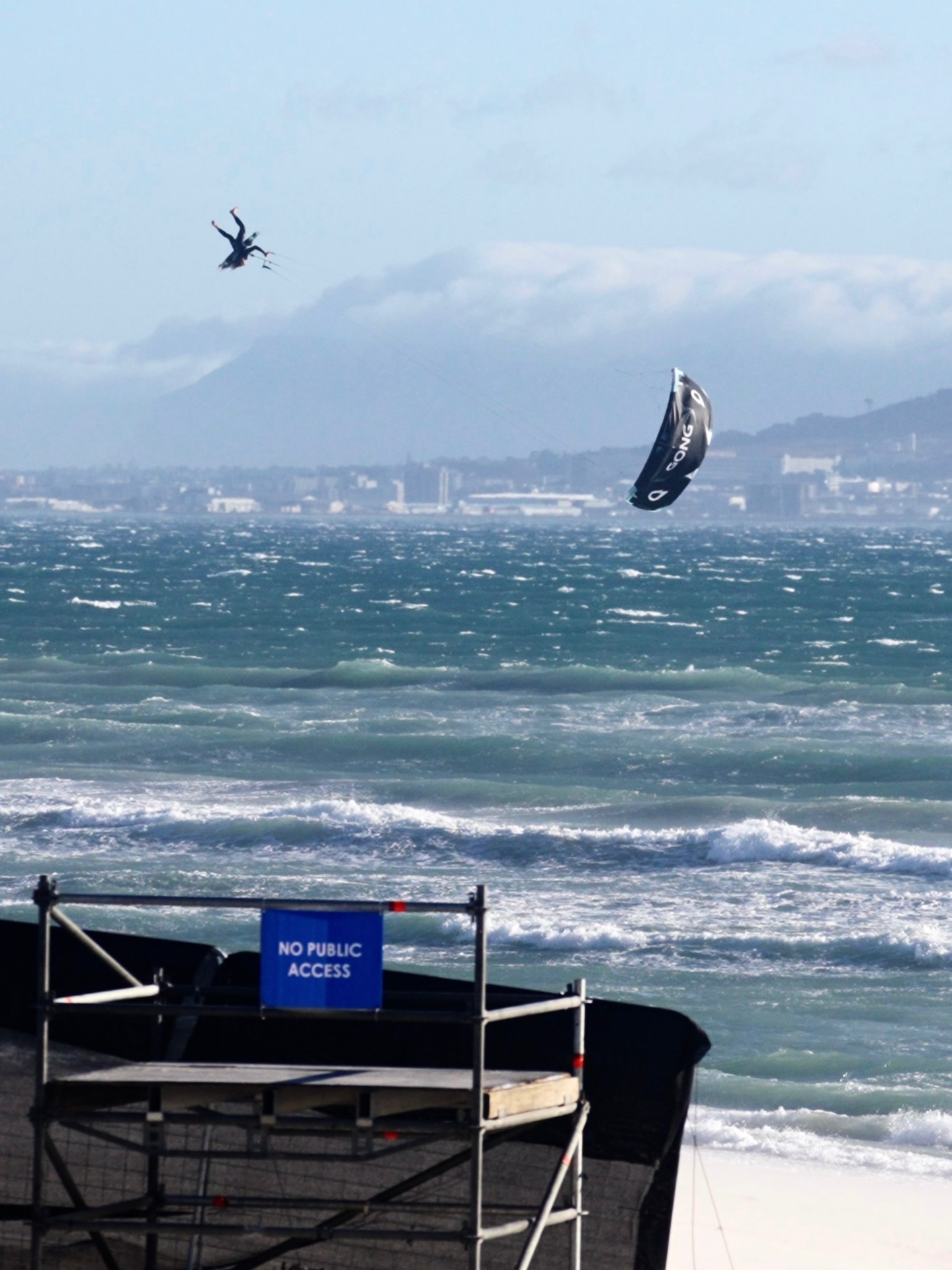 Yücel Paralik inverted mid-megaloop high above Table Bay in Cape Town